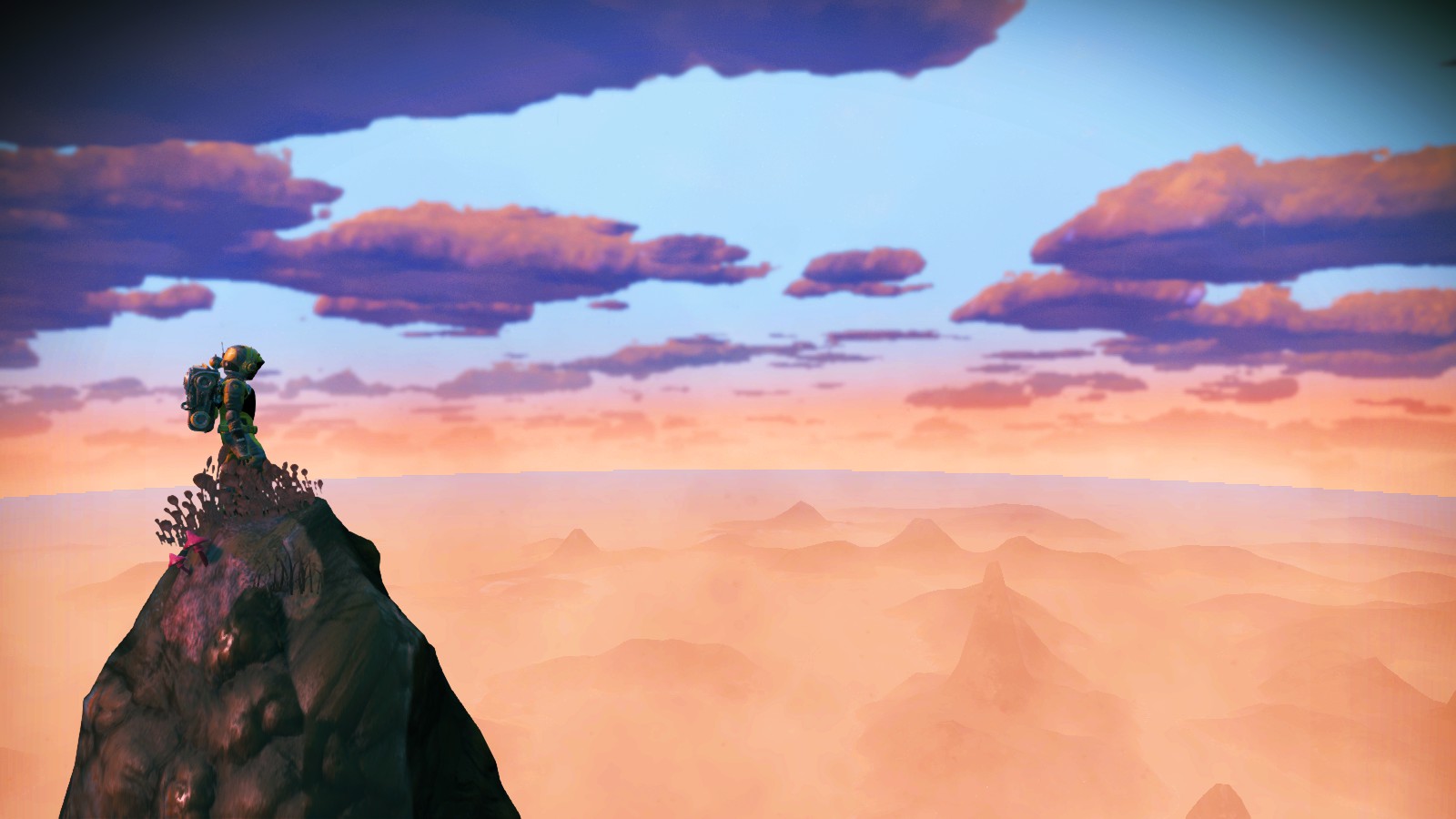 No Man's Sky, Expedition 3: Cartographers. A spacesuit-wearing traveler stands atop a very high peak, looking out over an orange-hazed planet filled with smaller peaks visible under the haze. A blue, clouded sky above.